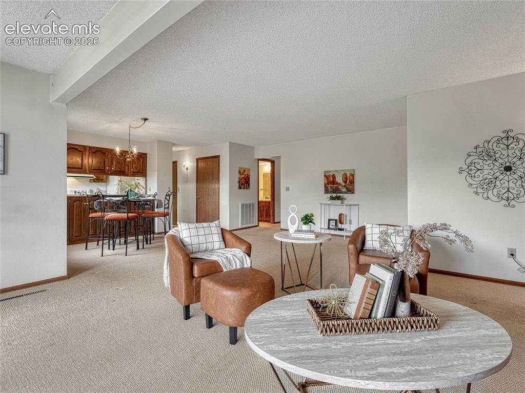 1146 Fontmore Road, Unit A Colorado Springs, CO 80904 - Photo 2 of 24 a living room with furniture and a table