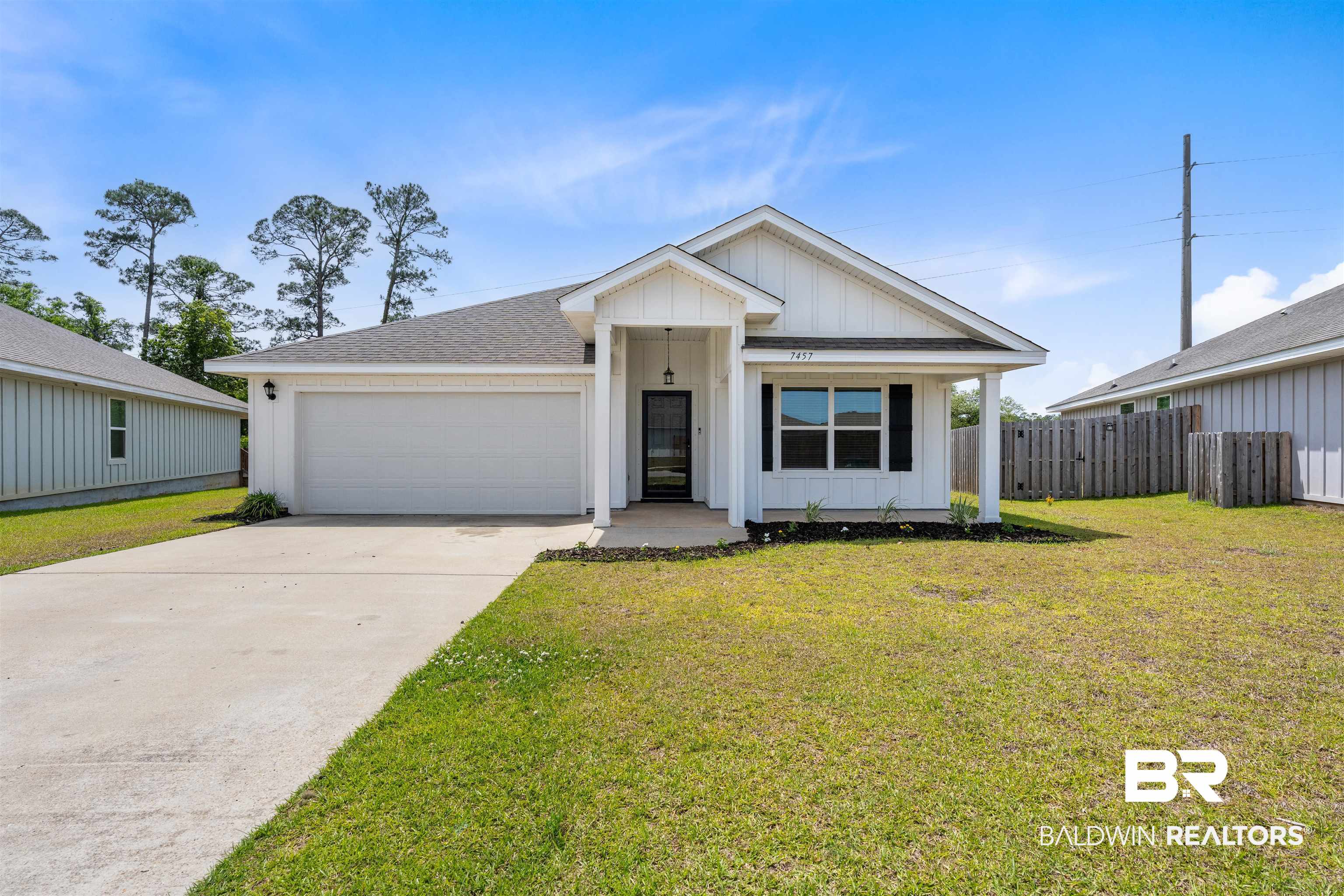 7457 Brompton Drive Foley, AL 36535 - Photo 1 of 24 View of front of house featuring board and batten siding, a garage, driveway, roof with shingles, and a porch