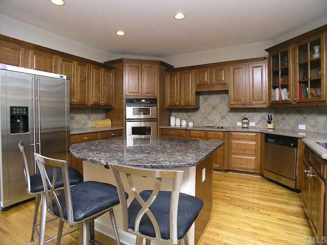 12225 Dunard Street Raleigh, NC 27614 - Photo 5 of 12 a kitchen with kitchen island granite countertop wooden cabinets a counter top space a sink and appliances