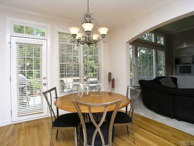 12225 Dunard Street Raleigh, NC 27614 - Photo 6 of 12 a dining room with furniture a chandelier and wooden floor