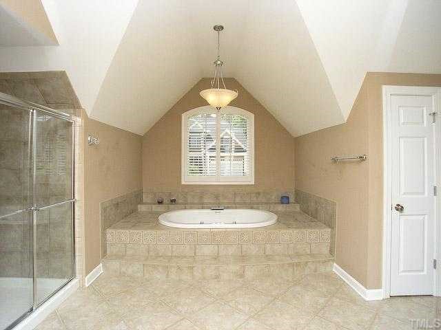 12225 Dunard Street Raleigh, NC 27614 - Photo 8 of 12 a bathroom with a sink a toilet a mirror and shower