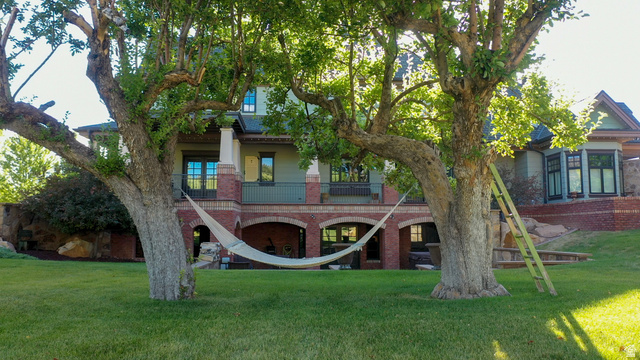 426 West Center Street Parowan, UT 84761 - Photo 83 of 107 Expansive green lawn with mature trees framing a multi-story residence