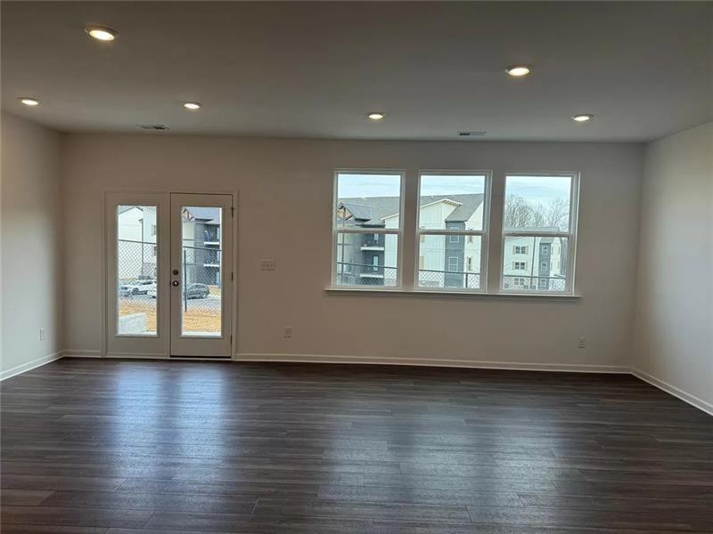 100 Mission Boulevard Pendergrass, GA 30567 - Photo 2 of 17 a view of an empty room with wooden floor and windows