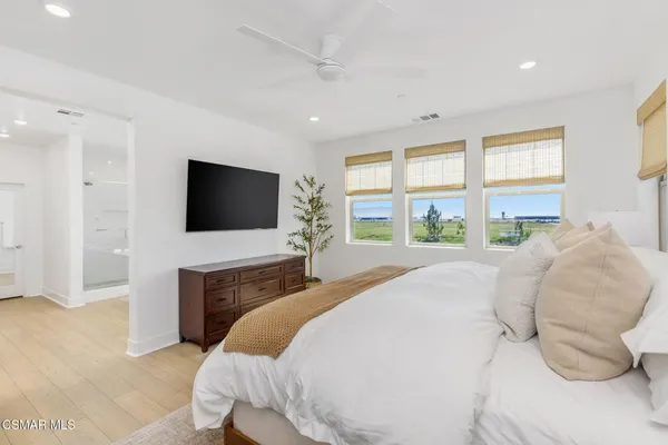 a bedroom with a bed and a flat screen tv