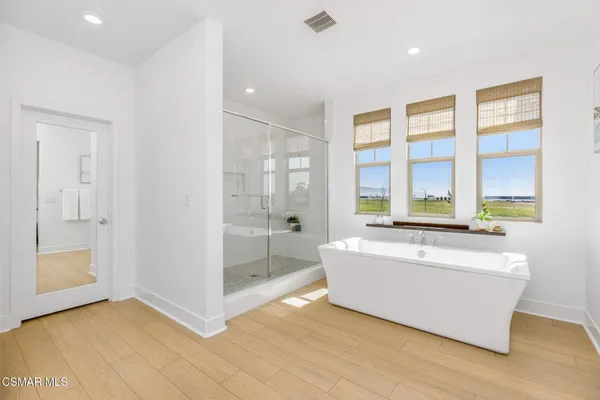 a living room with a large window and wooden floor