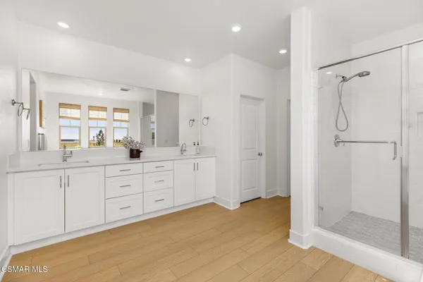 a spacious bathroom with a granite countertop sink mirror and shower