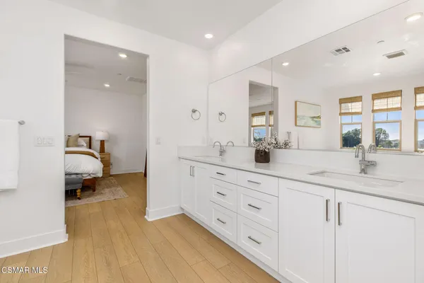 a en suite bathroom with double sink and a mirror