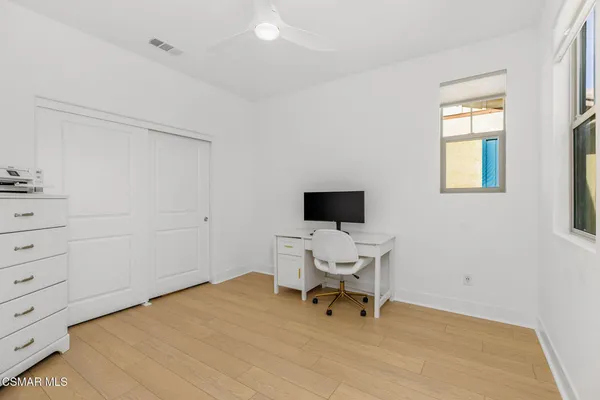 a workspace with a chair and a window