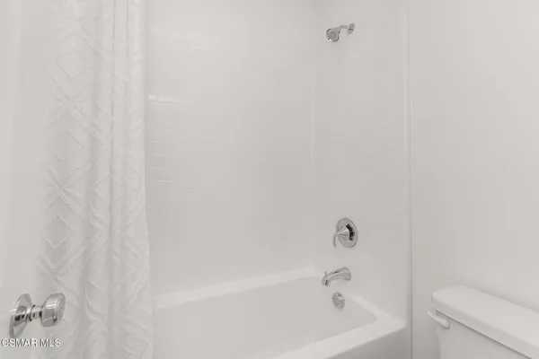 a white bath tub and a toilet