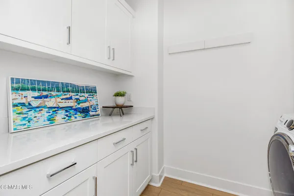 a sink with white cabinets
