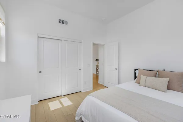 a bedroom with a bed and a mirror