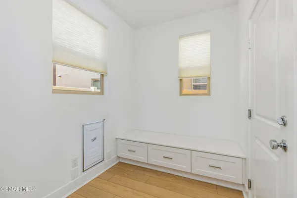 a view of room with cabinet and wooden floor