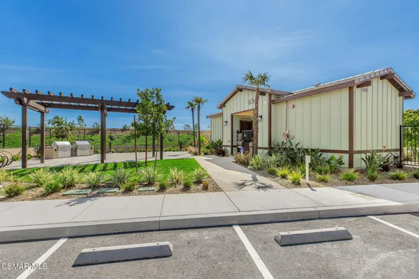a front view of a house with a garden and plants