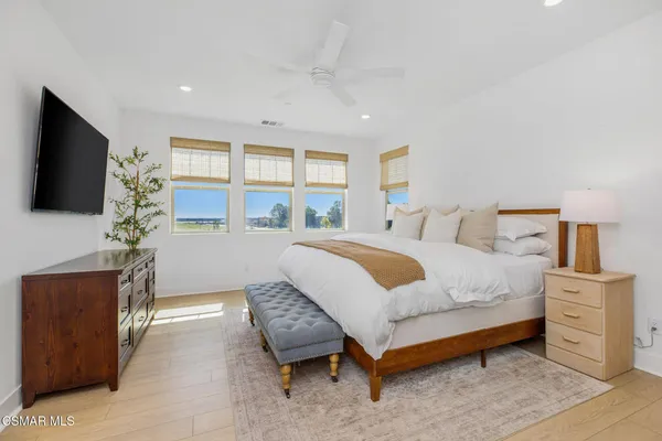 a bedroom with furniture and a flat screen tv