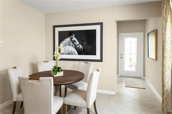 a view of a dining room with a table and chairs