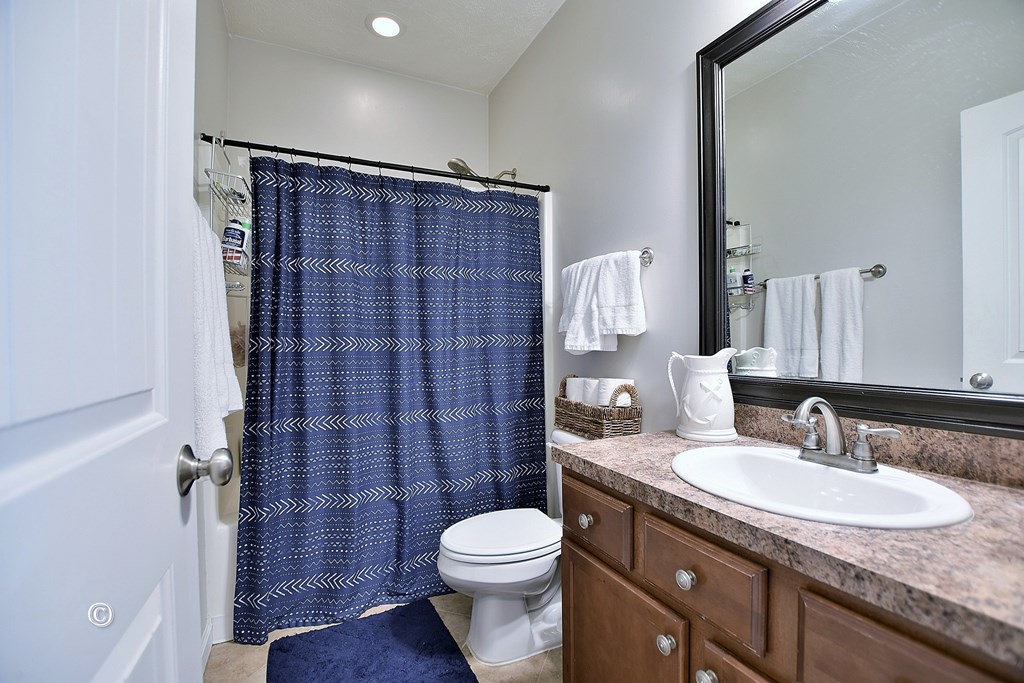 4678 Ivy Patch Drive Fortson, GA 31808 - Photo 16 of 28 a bathroom with a granite countertop sink toilet and shower