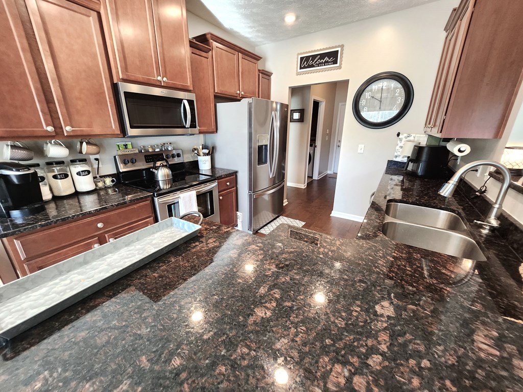 4678 Ivy Patch Drive Fortson, GA 31808 - Photo 9 of 28 a view of a kitchen with a sink and a stove