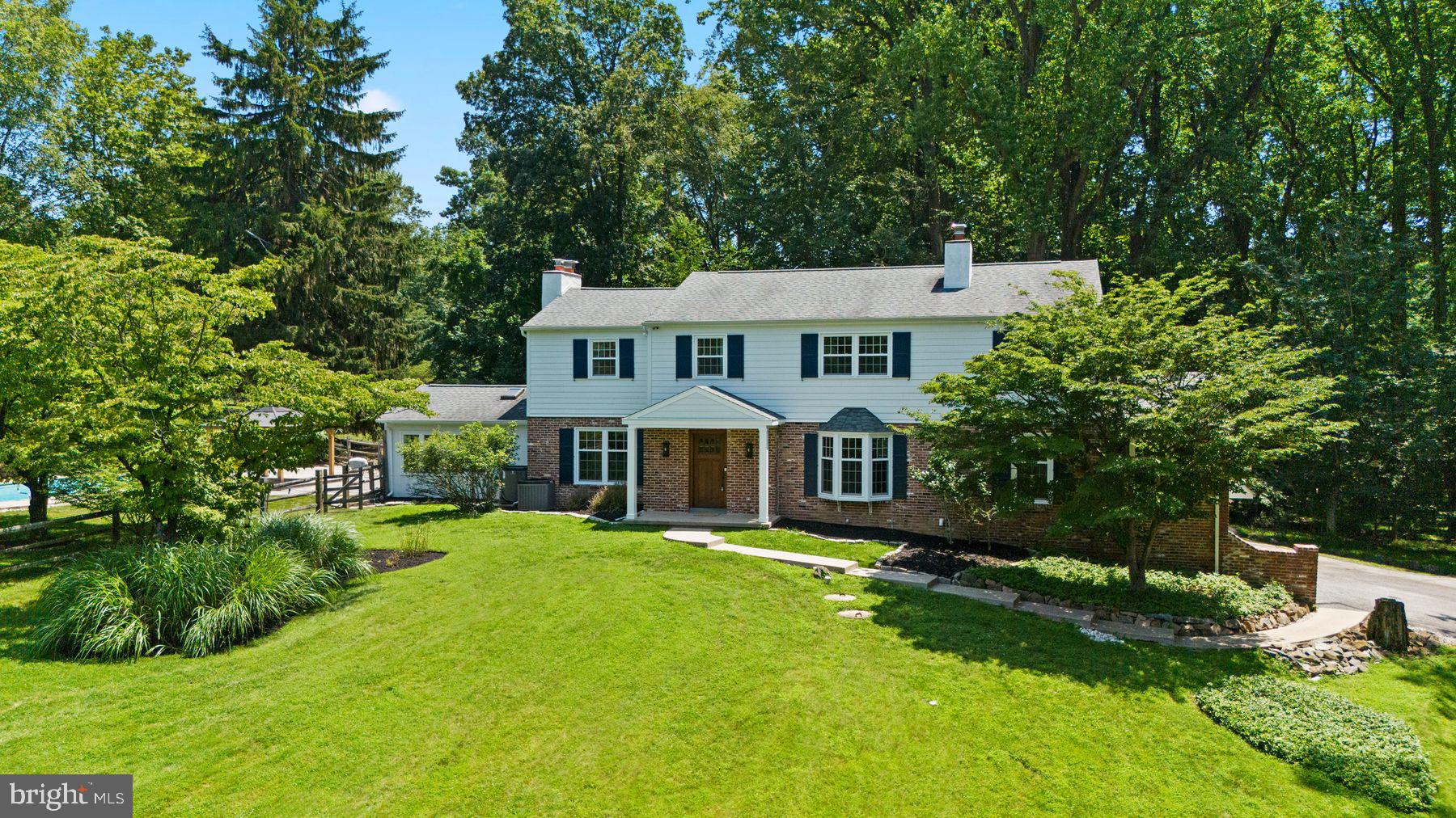 241 Line Road Malvern, PA 19355 - Photo 1 of 33 a front view of a house with a garden and trees