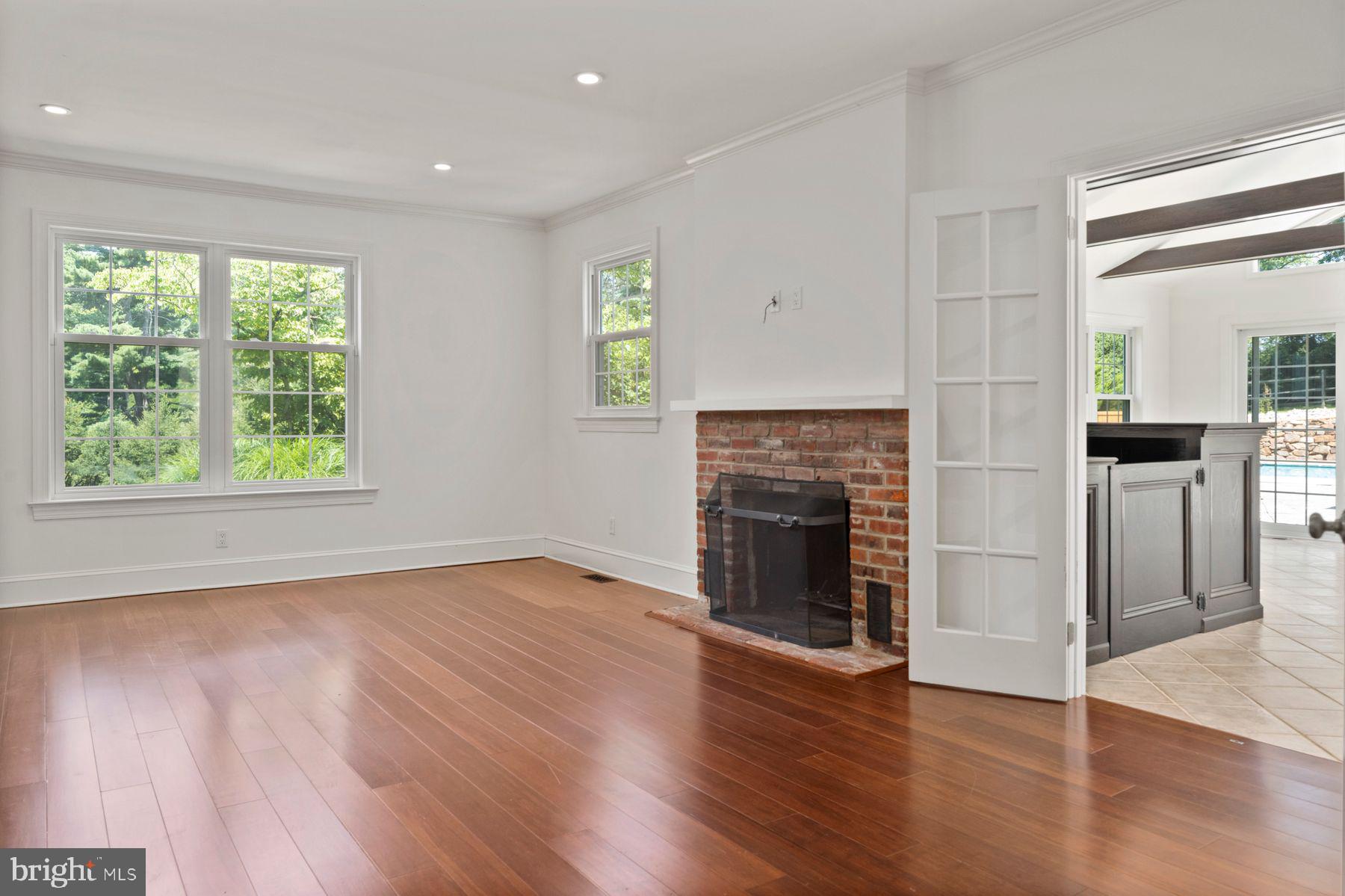 241 Line Road Malvern, PA 19355 - Photo 11 of 33 an empty room with wooden floor fireplace and windows