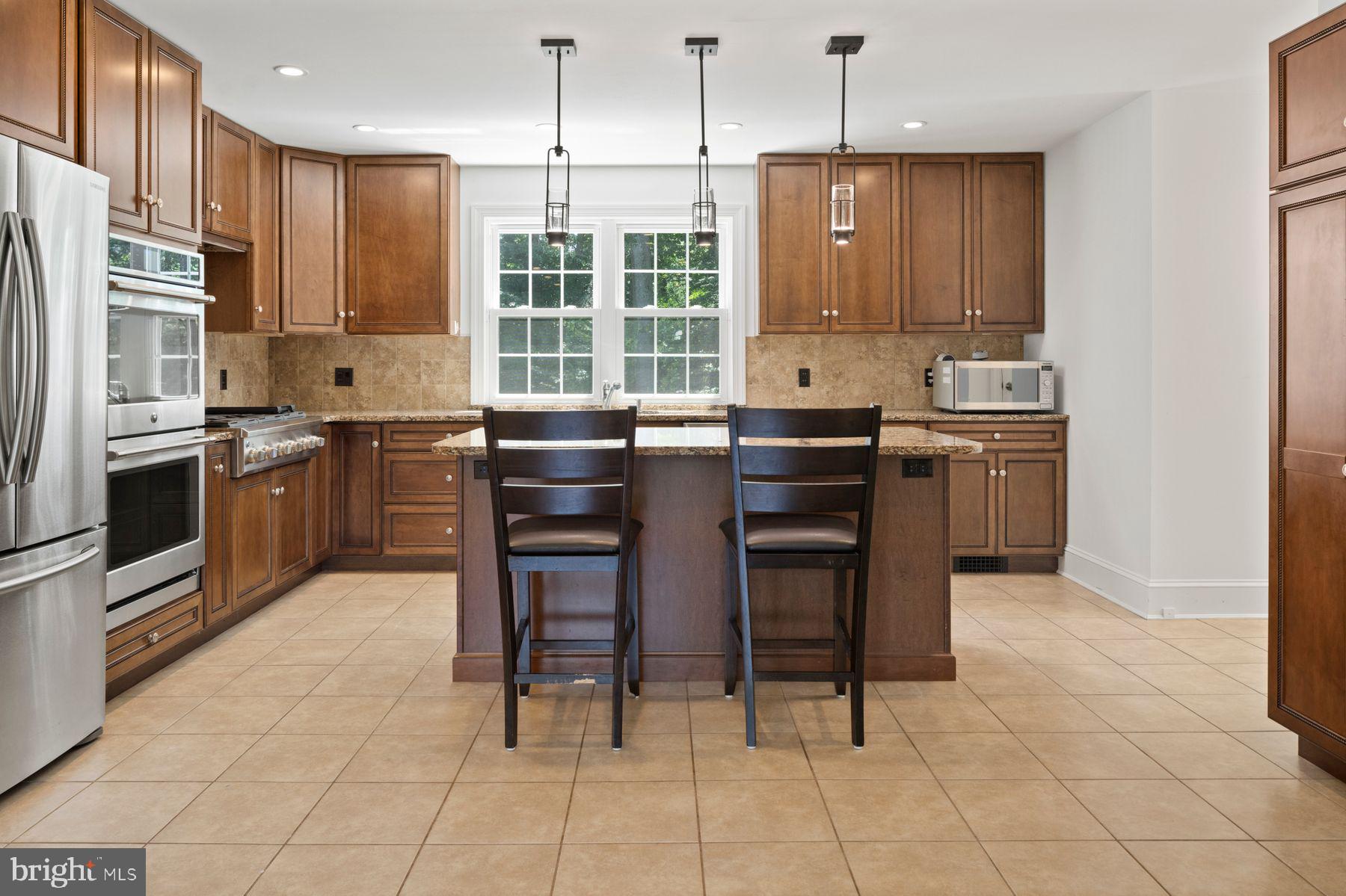 241 Line Road Malvern, PA 19355 - Photo 5 of 33 a kitchen with stainless steel appliances granite countertop a stove top oven a refrigerator a sink and chairs