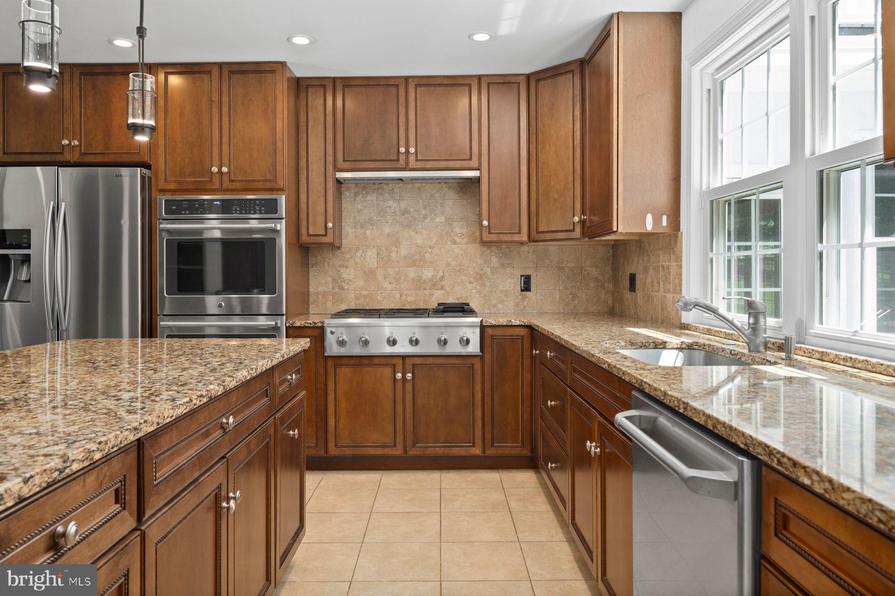 241 Line Road Malvern, PA 19355 - Photo 6 of 33 a kitchen with kitchen island granite countertop a sink stove and refrigerator