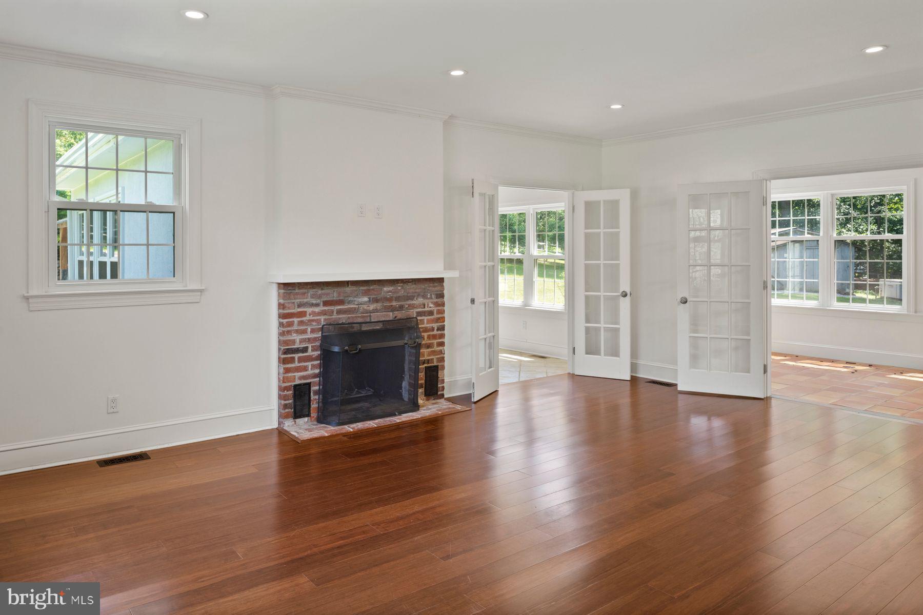 241 Line Road Malvern, PA 19355 - Photo 10 of 33 an empty room with windows fireplace and wooden floor