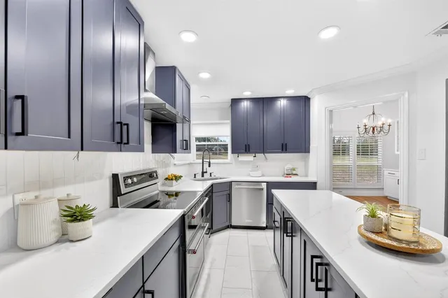 a kitchen with a sink stove and cabinets