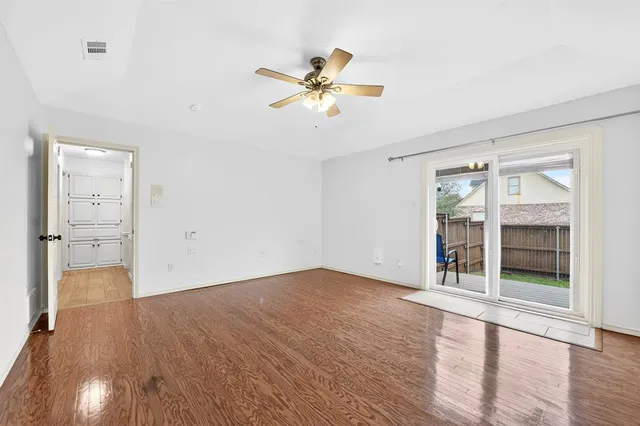 wooden floor in an empty room with a window