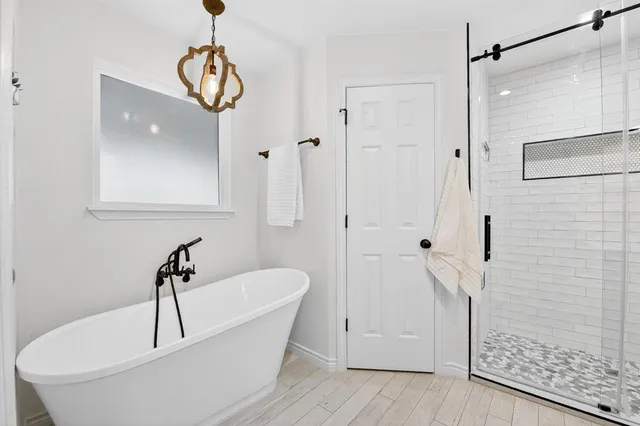 a bathroom with a bathtub and shower