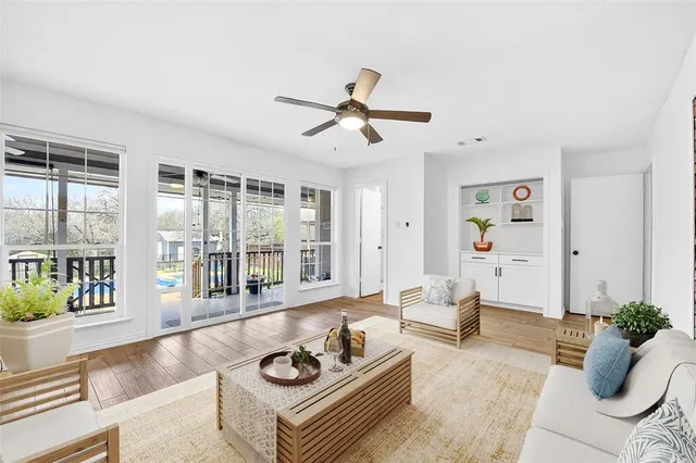 a living room with furniture and floor to ceiling windows