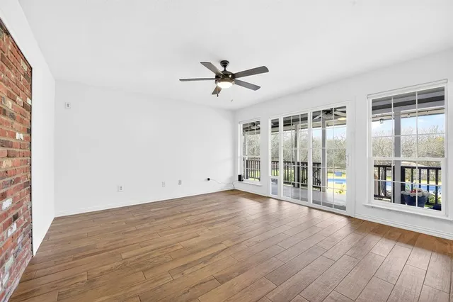 wooden floor in an empty room with a window