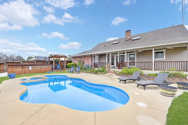 a view of a house with swimming pool and porch