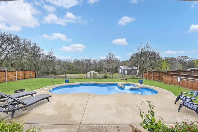 a view of swimming pool with lounge chair and lake view