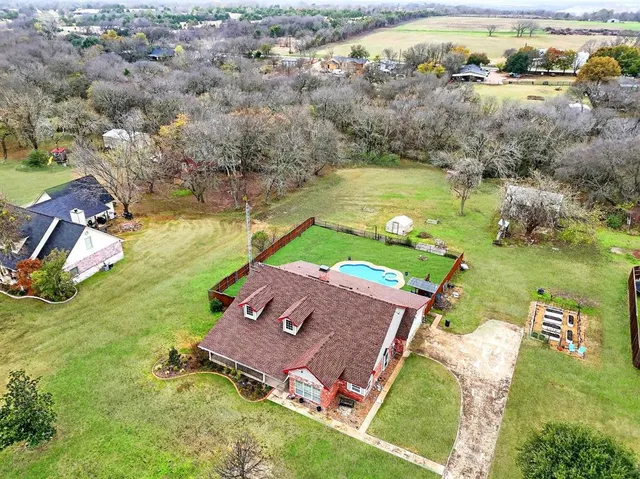 an aerial view of a house with a garden