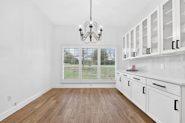 a view of a kitchen with wooden floor and windows