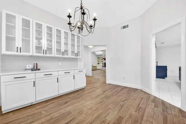 a large kitchen with stainless steel appliances granite countertop a dishwasher a stove and a wooden floors