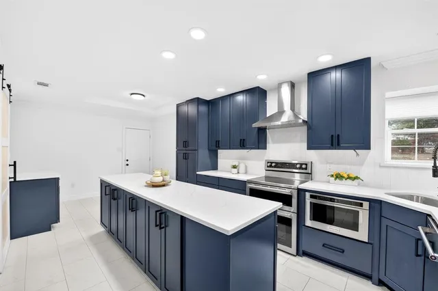 a kitchen that has a stove and a sink