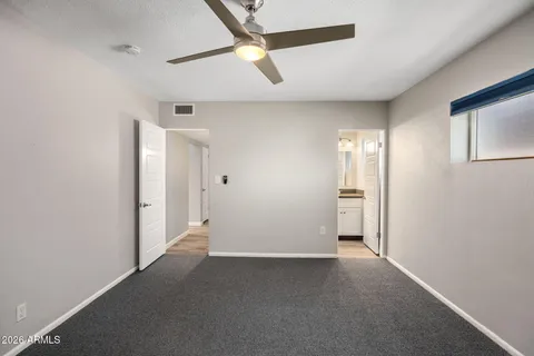 a view of hallway with a ceiling fan