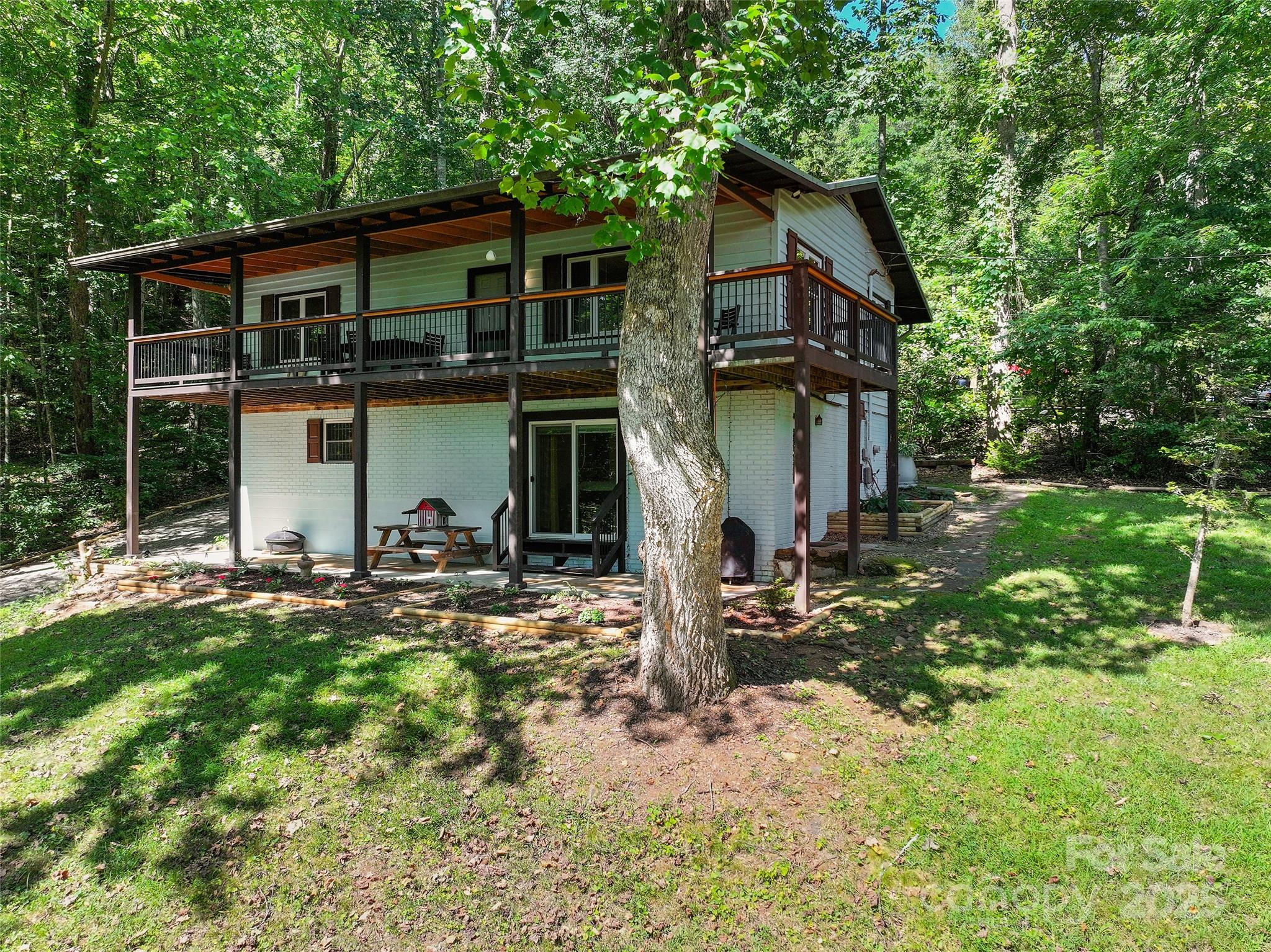 a view of a house with backyard and sitting area