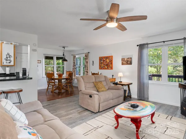 a living room with furniture a rug and a large window
