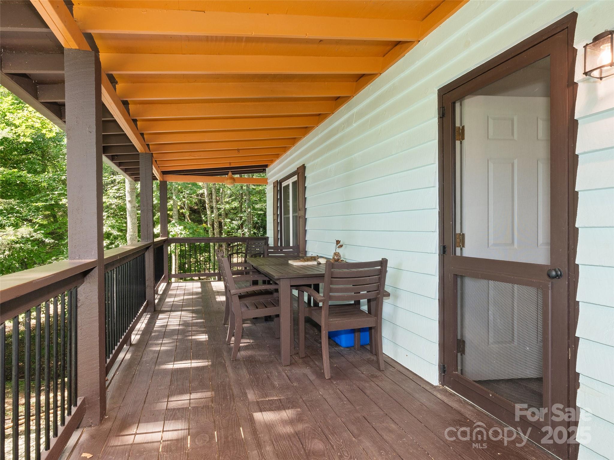 290 Turkey Pen Road Franklin, NC 28734 - Photo 15 of 37 a view of a patio with table and chairs with wooden floor and fence