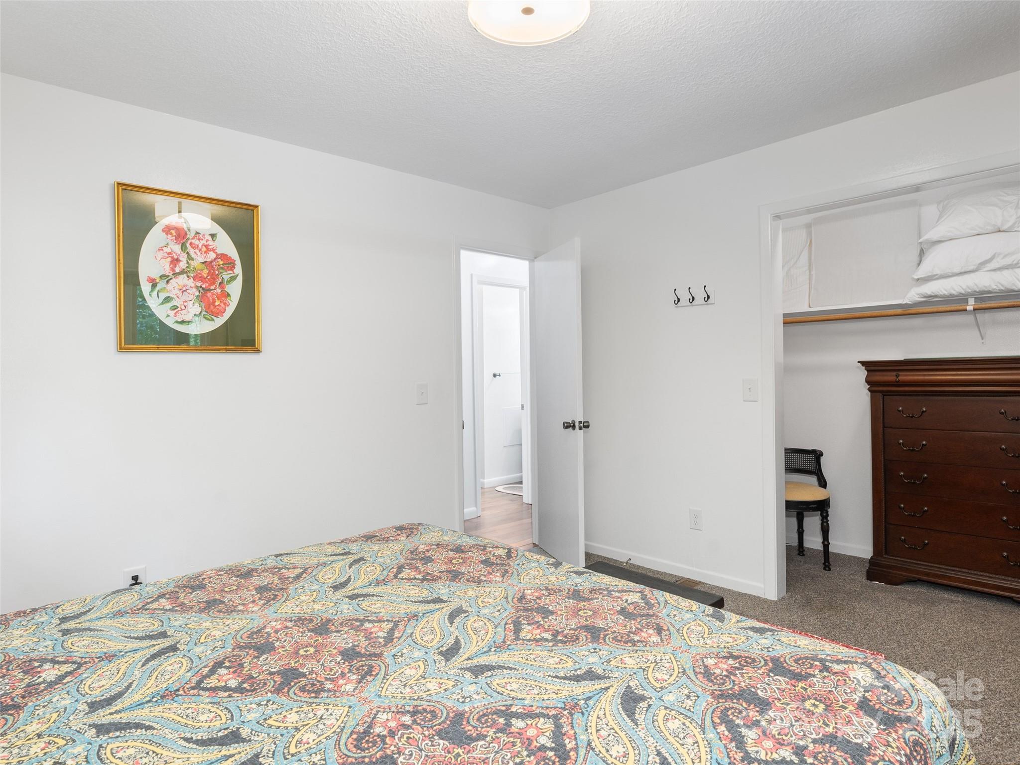 290 Turkey Pen Road Franklin, NC 28734 - Photo 18 of 37 a bedroom with a bed and a fireplace