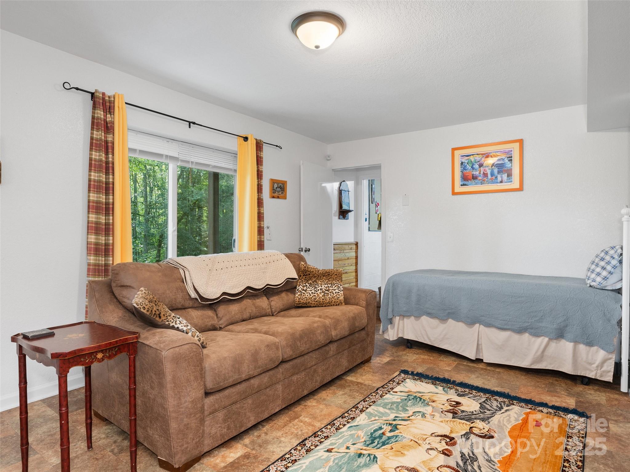 290 Turkey Pen Road Franklin, NC 28734 - Photo 23 of 37 a living room with a bed and a window