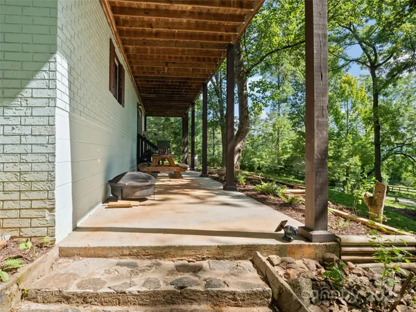 a view of a backyard with table and chairs and wooden fence