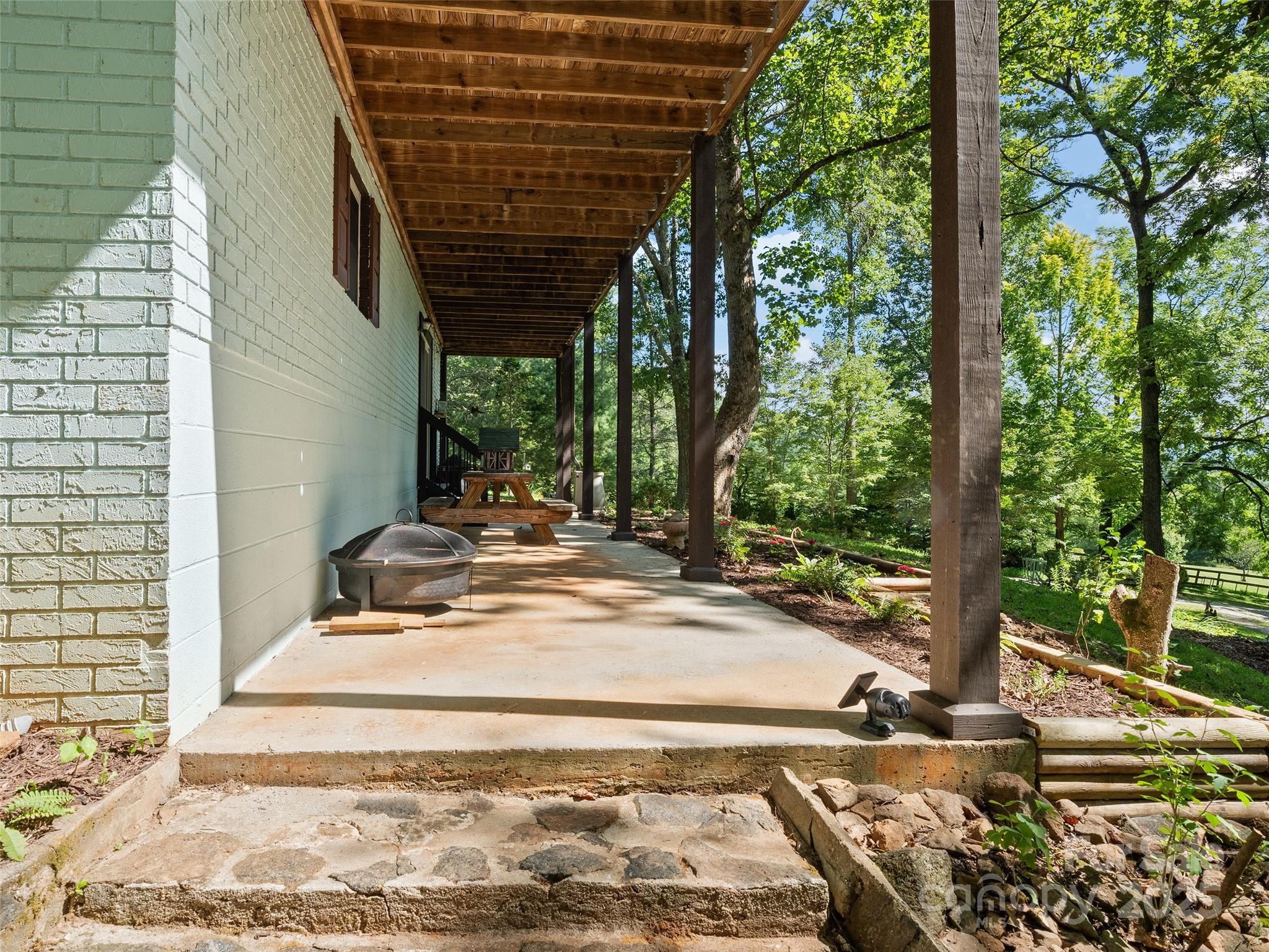 290 Turkey Pen Road Franklin, NC 28734 - Photo 24 of 37 a view of a backyard with table and chairs and wooden fence