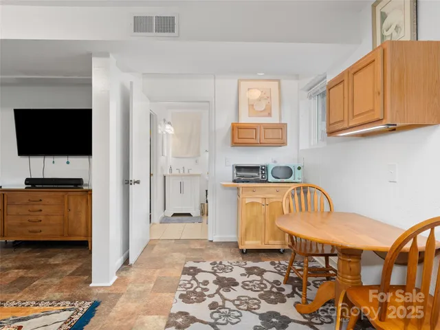 a bedroom with furniture and a flat screen tv