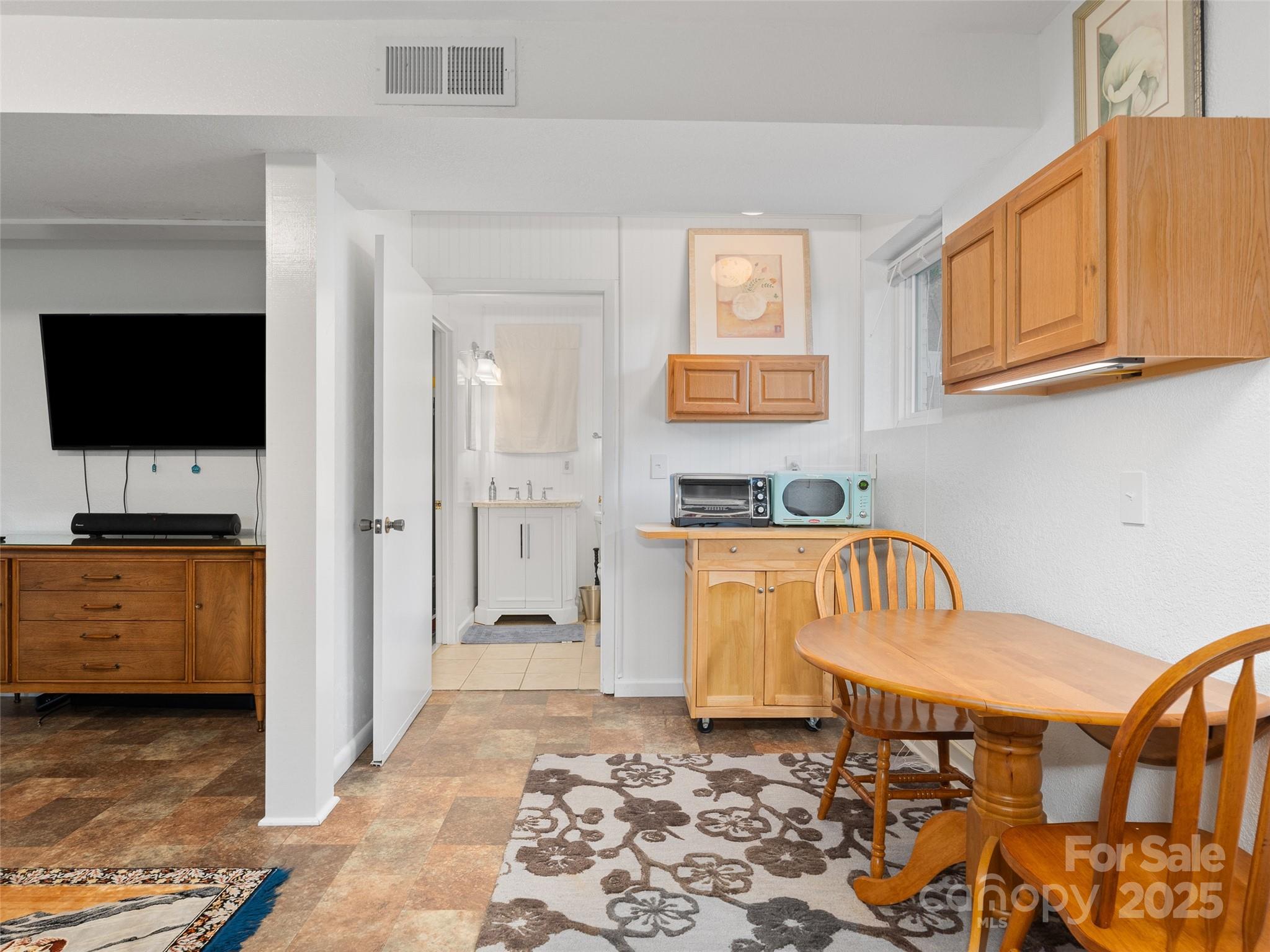 290 Turkey Pen Road Franklin, NC 28734 - Photo 27 of 37 a bedroom with furniture and a flat screen tv