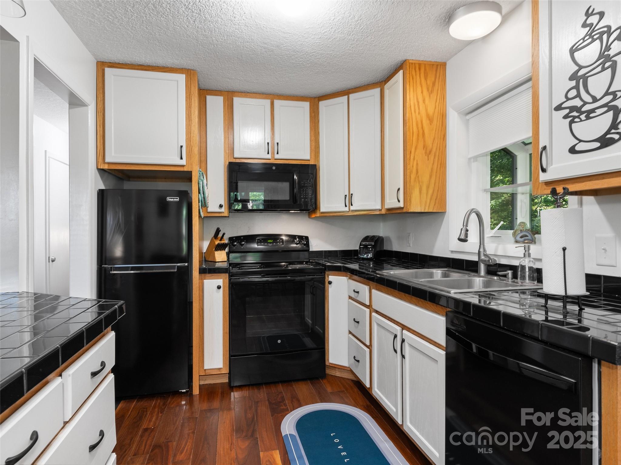 290 Turkey Pen Road Franklin, NC 28734 - Photo 8 of 37 a kitchen with a refrigerator stove and sink