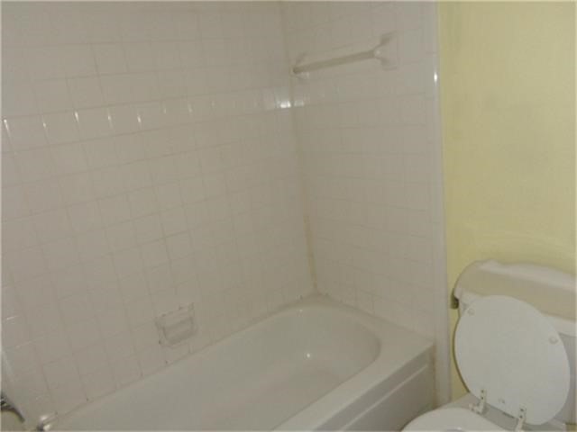 16714 Sinaloa Drive Houston, TX 77083 - Photo 5 of 10 a white bath tub sitting next to a toilet