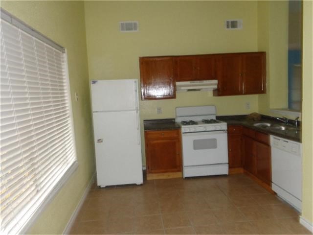 16714 Sinaloa Drive Houston, TX 77083 - Photo 8 of 10 a kitchen with a stove and a refrigerator